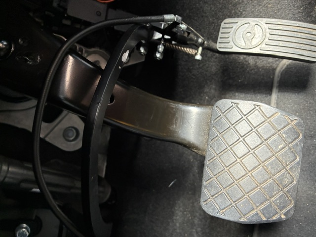 Technician installing the replacement pedal mechanism into the vehicle