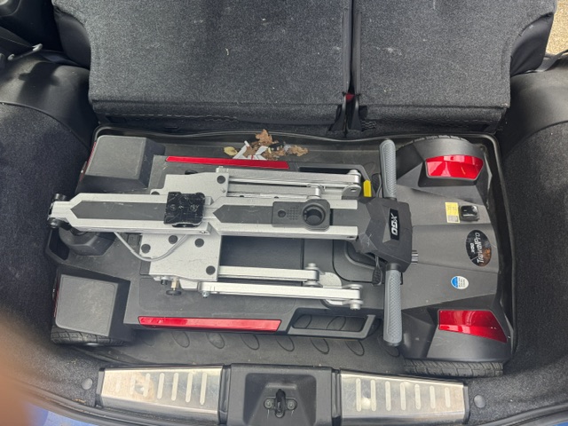 Mobility scooter attached to the Brig-Ayd hoist mechanism