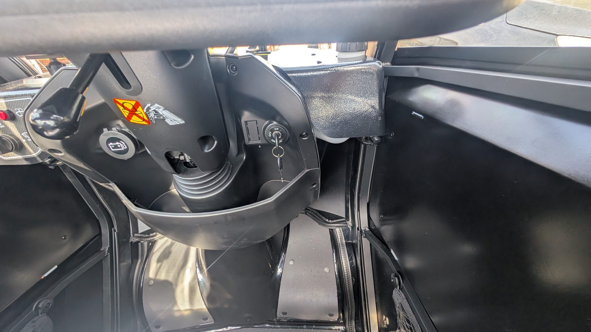 Interior view of the tiller controls and seating inside the cabin mobility scooter