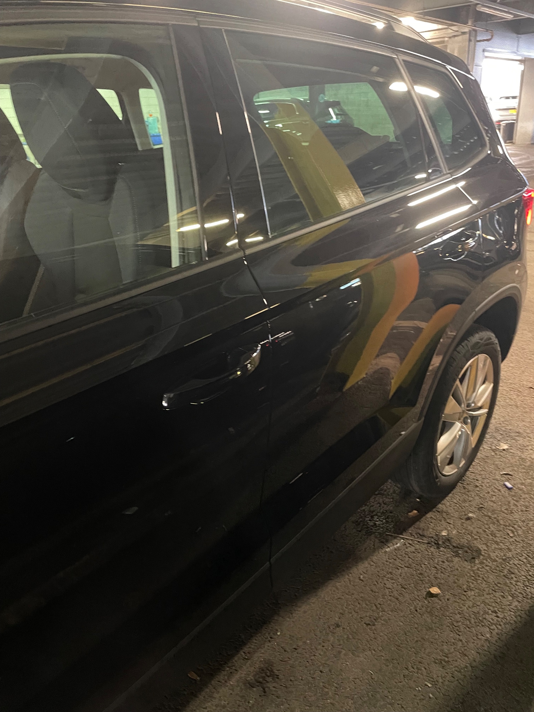 Mobility scooter hoist arm extended out of a Skoda Karoq boot