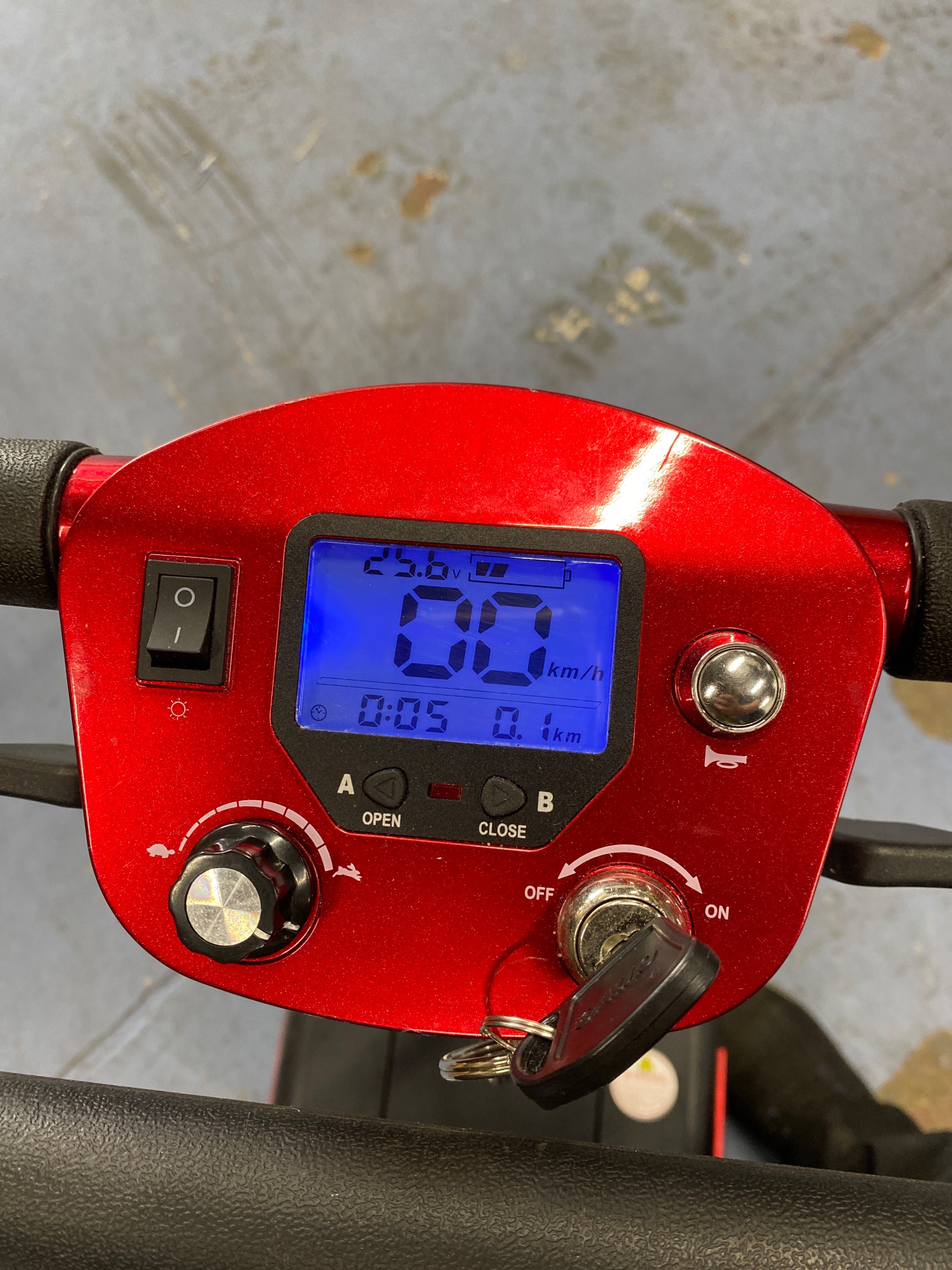 Technician inspecting the steering tracking on a folding scooter