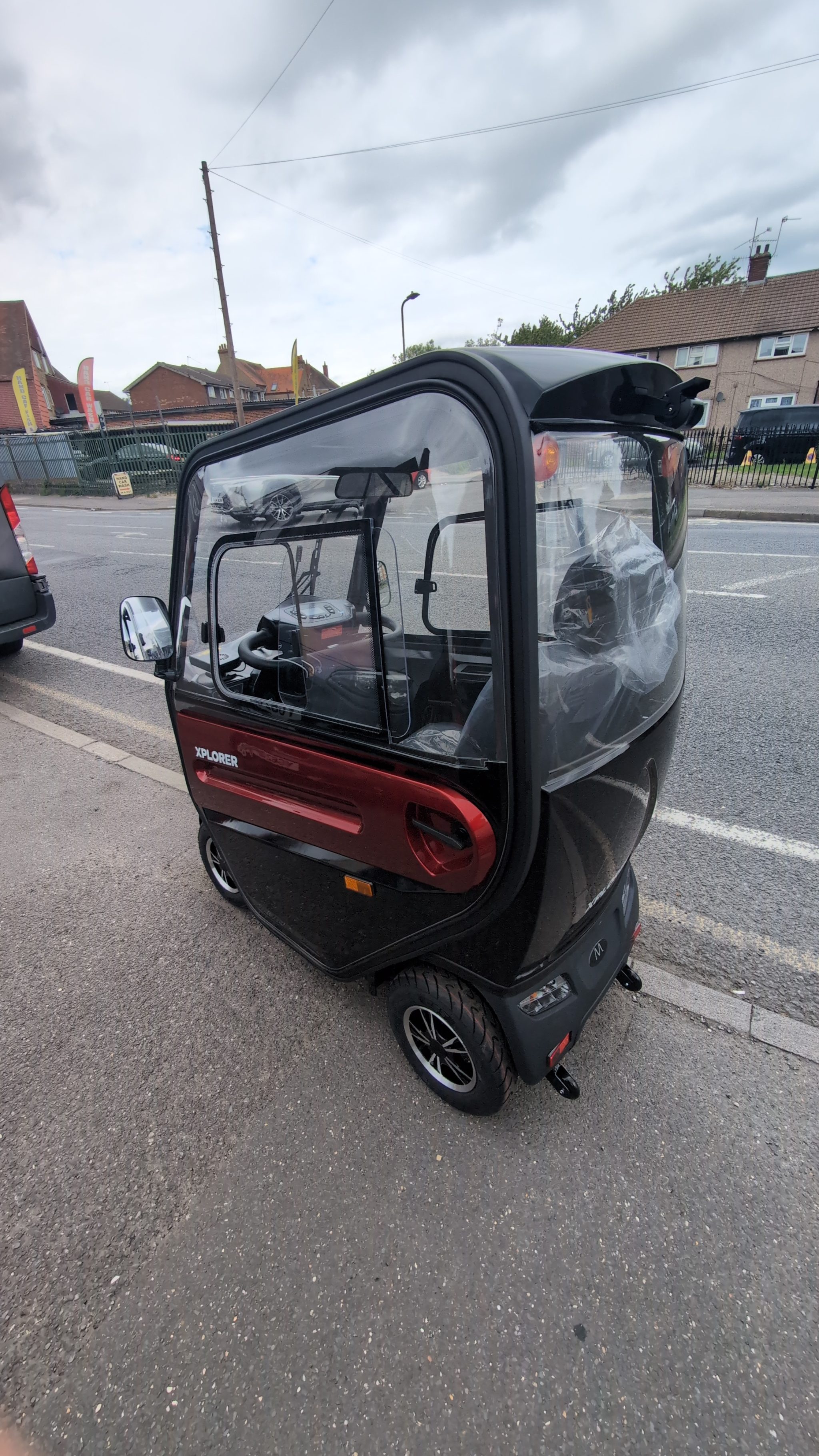 Technician assessing components on a road legal mobility scooter