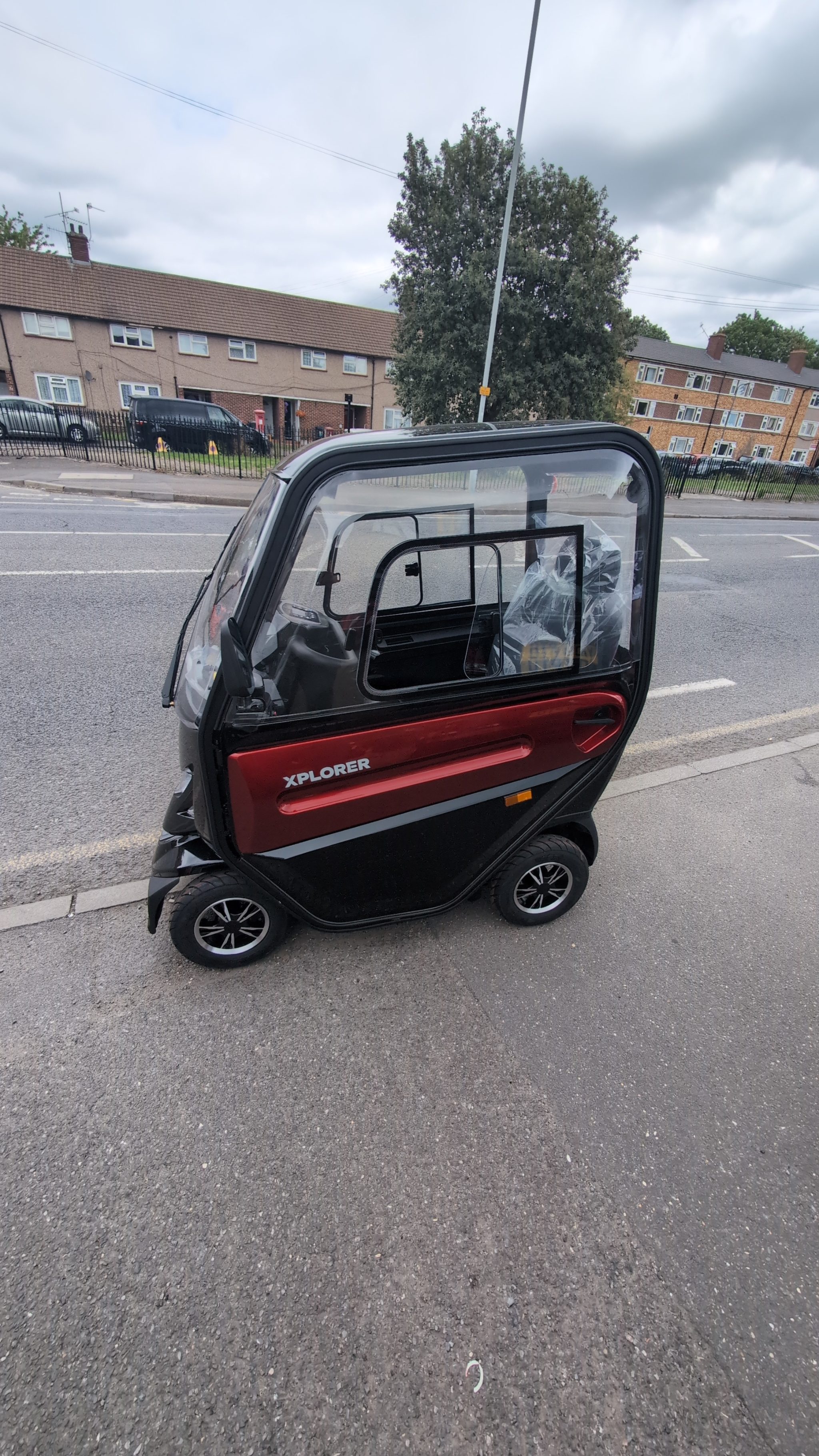 Refitting replacement parts on a red Motion Healthcare mobility scooter