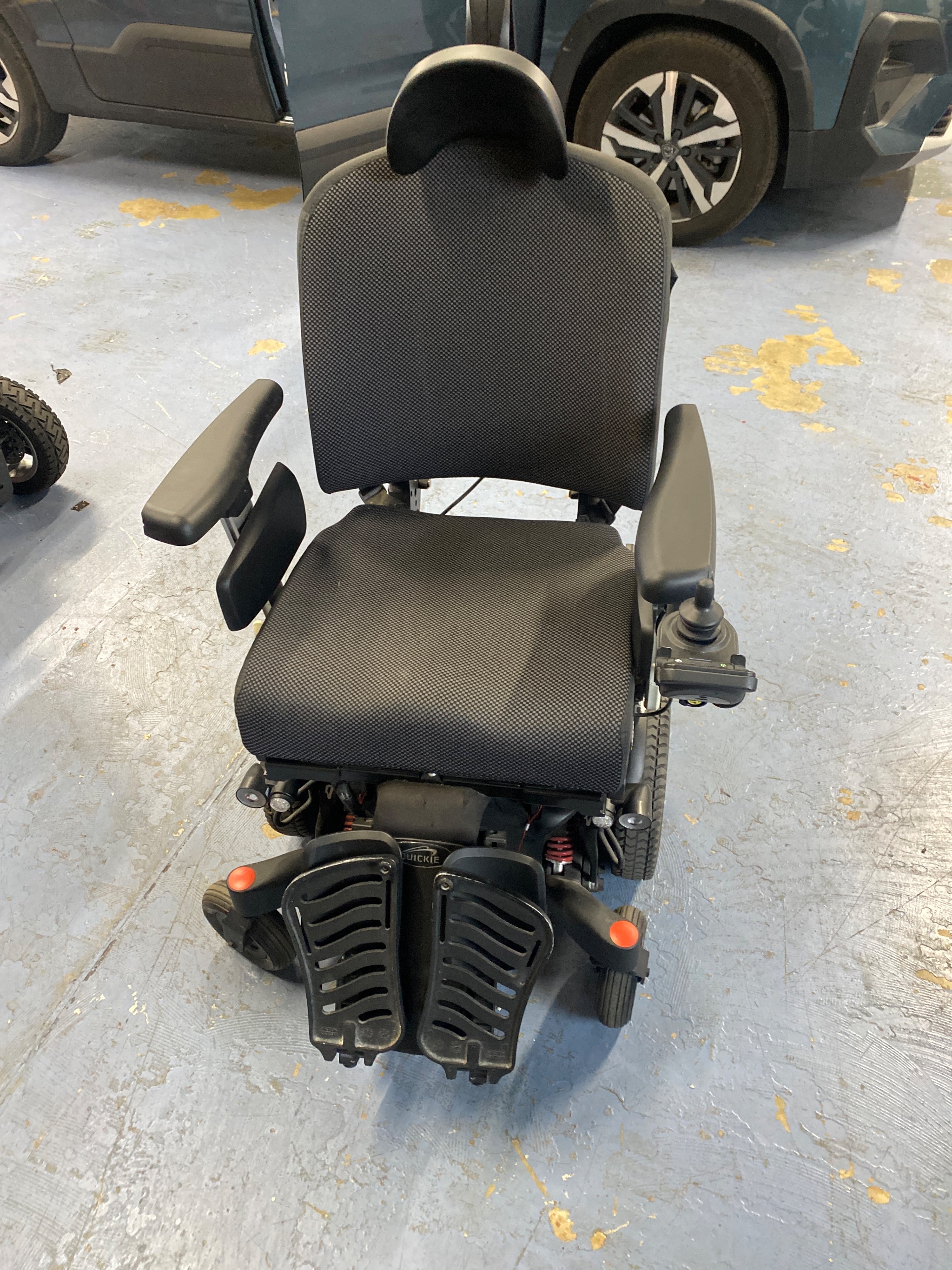 Technician testing powerchair battery voltage