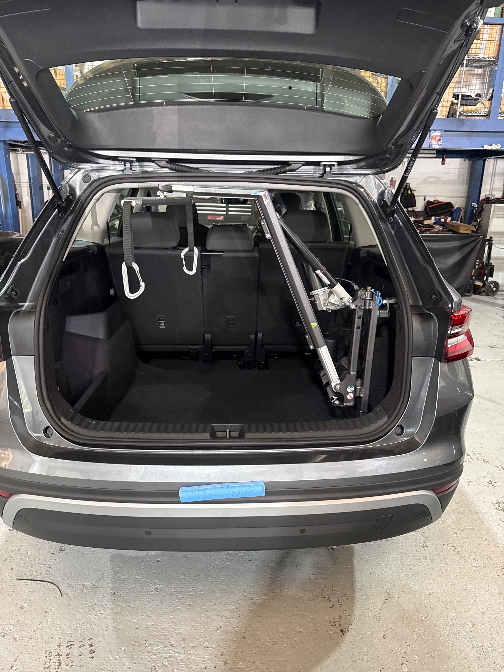 Close-up of the Autochair SmartLifter hoist arm and lifting bracket