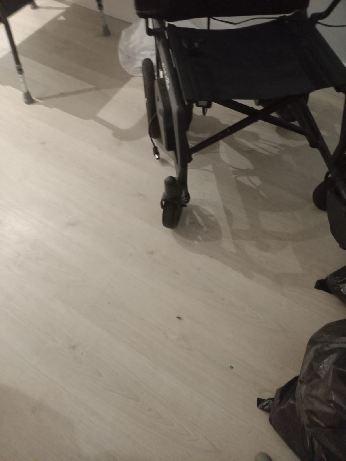 Technician inspecting a power wheelchair during annual service