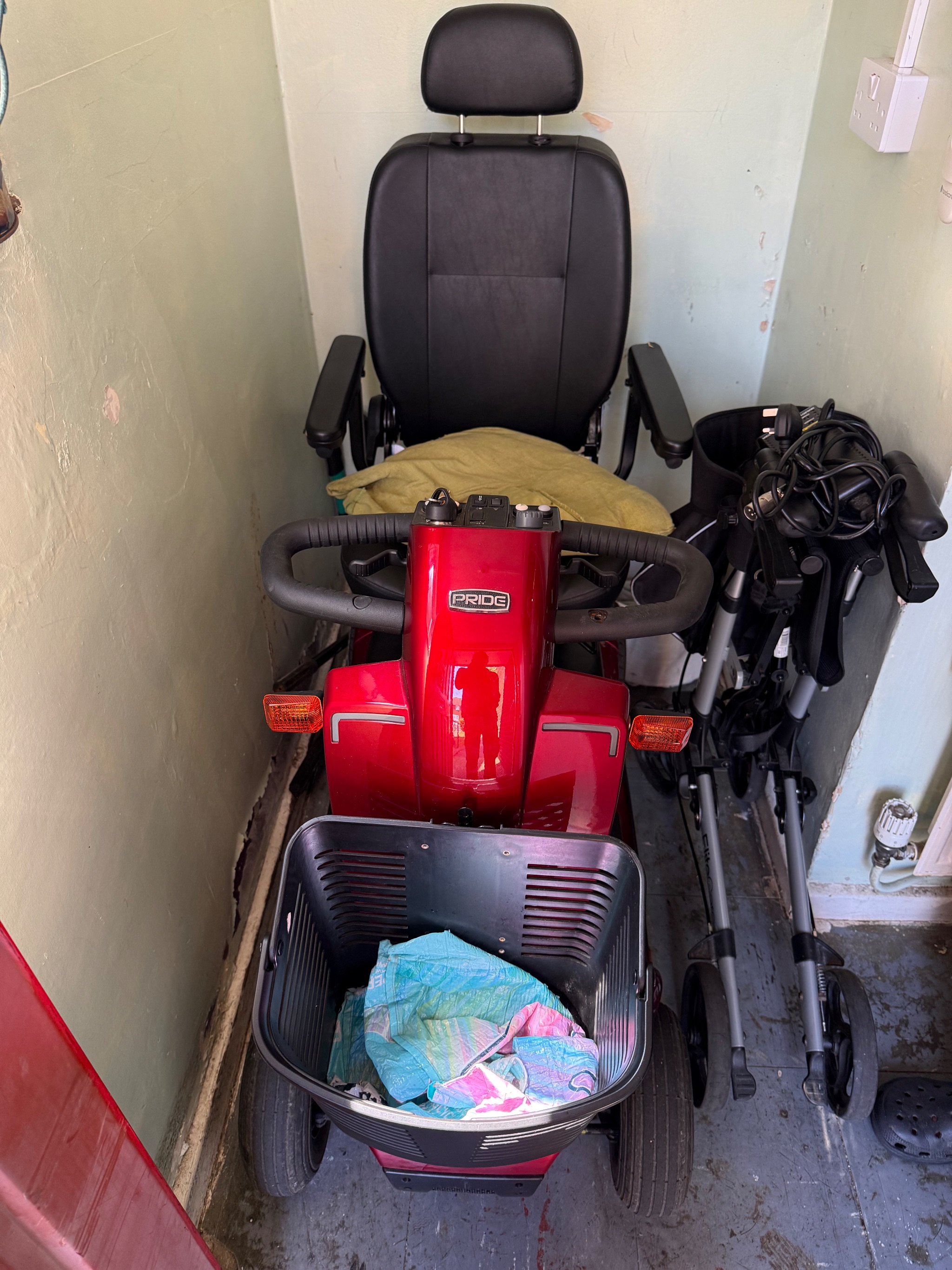 Technician inspecting controls on a Pride Colt Pursuit 2.0 scooter