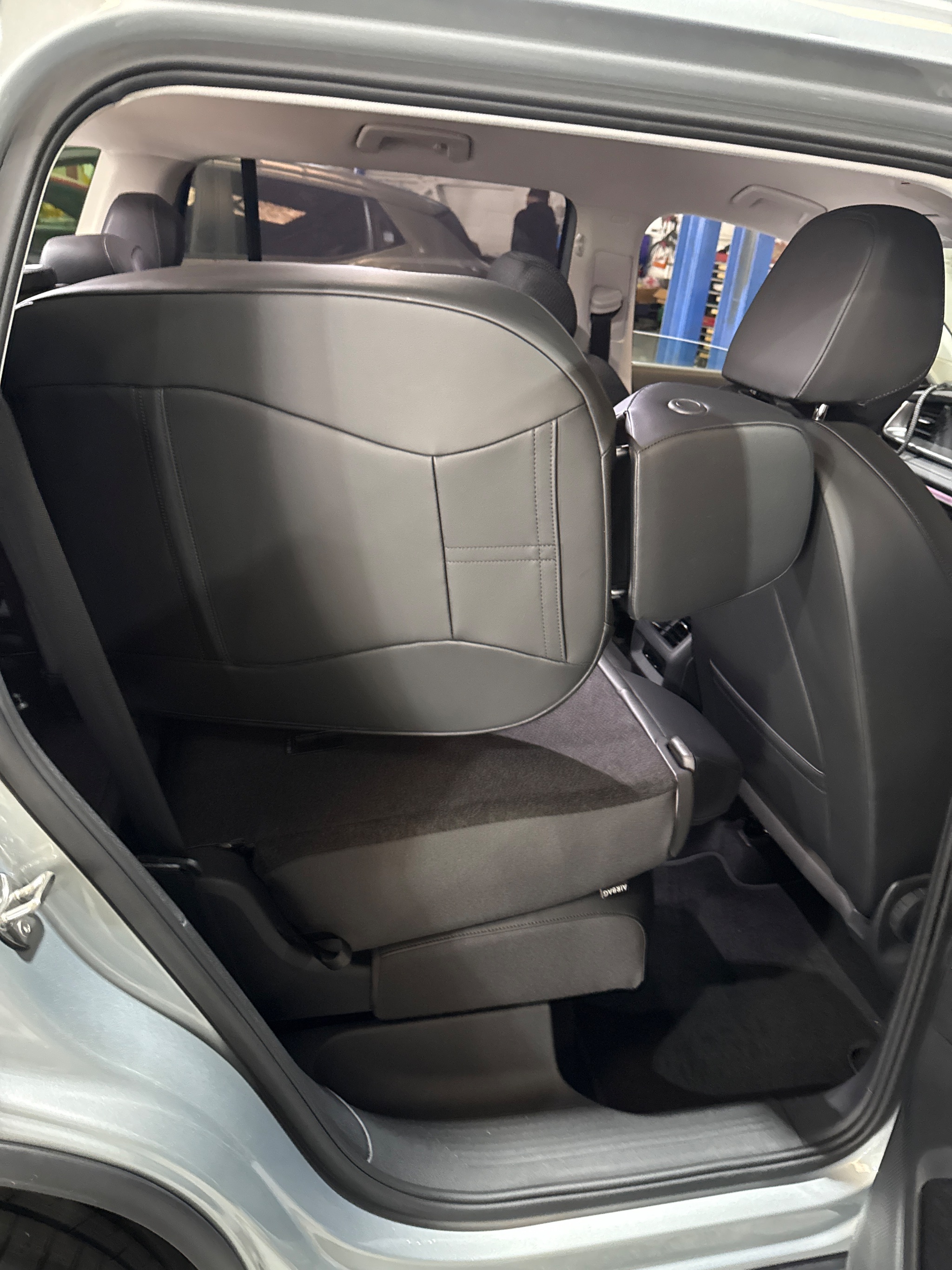 Lowering swivel seat extended to transfer height beside VW Tayron door