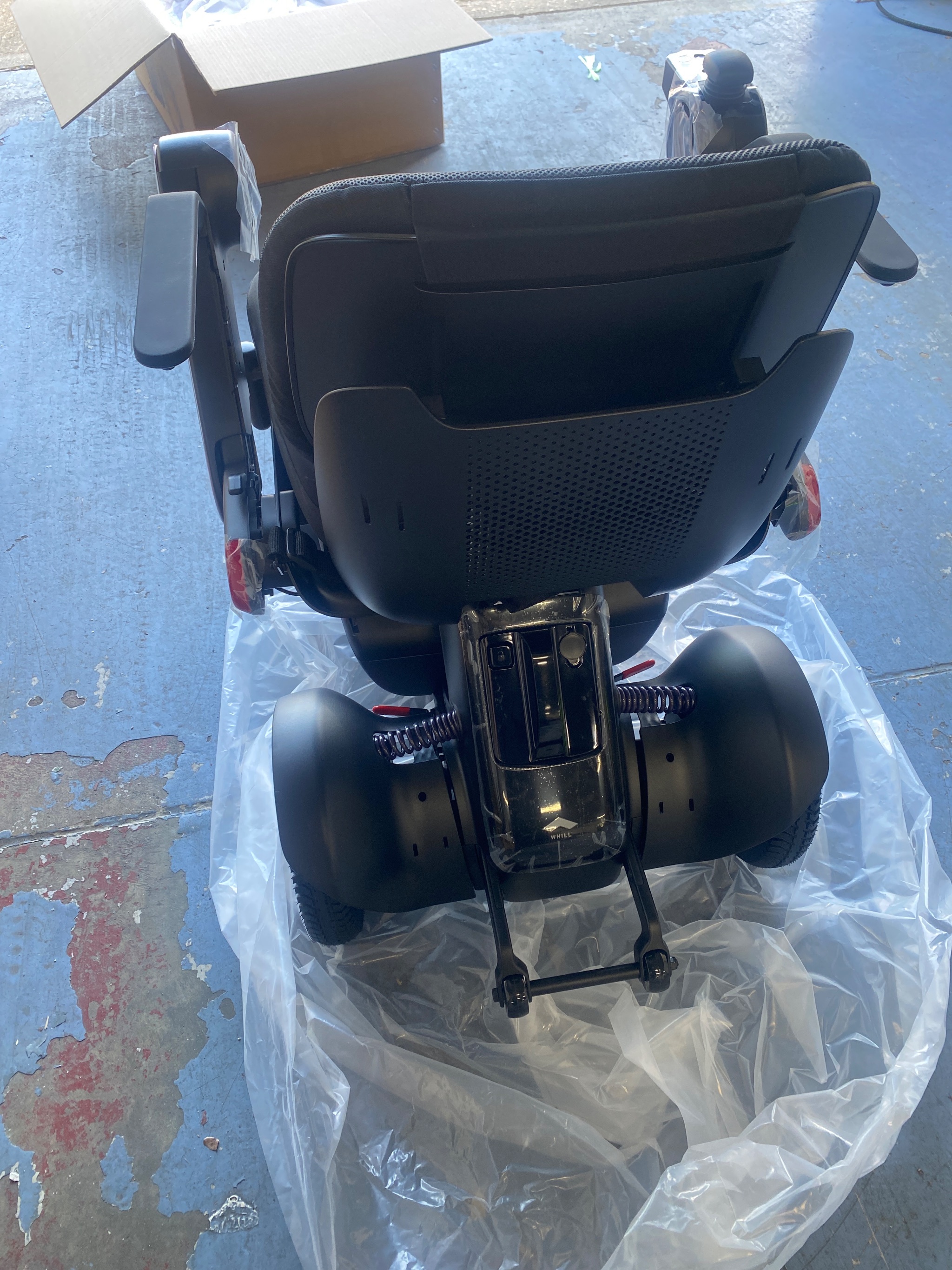 Side profile of the Whill Model C2 powered wheelchair