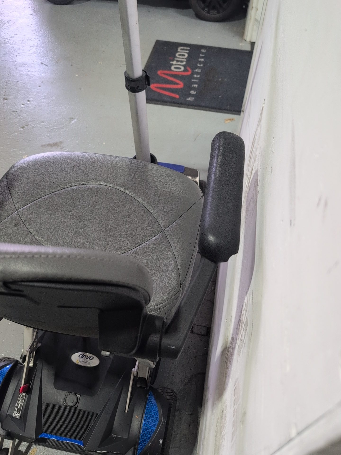 Technician servicing a folding mobility scooter mechanism