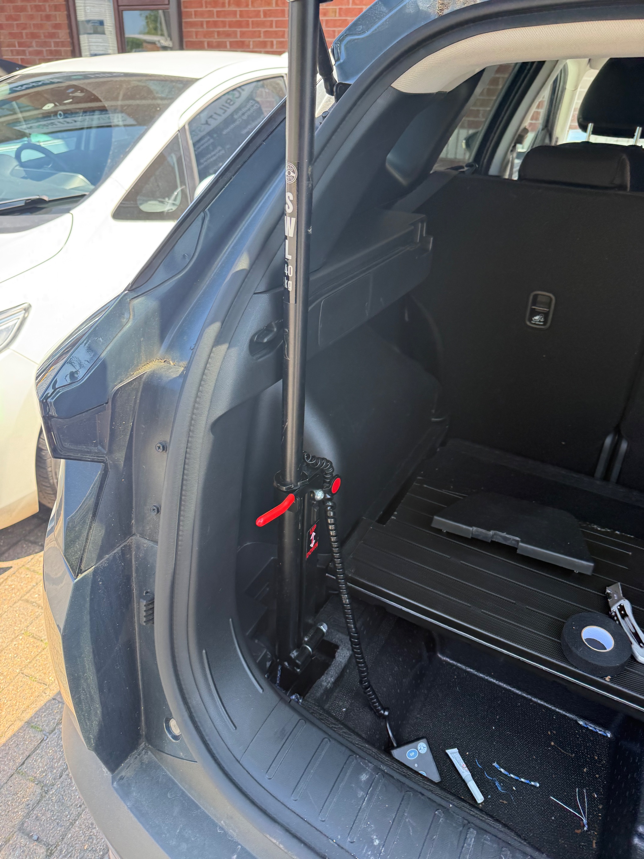 Technician repairing the lifting cord inside a vehicle boot hoist