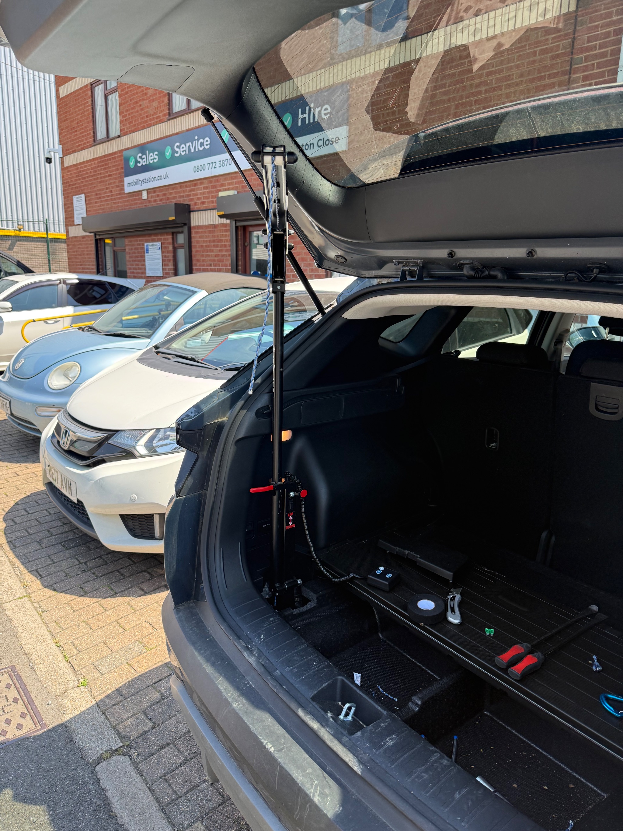 Testing the repaired boot hoist with a mobility scooter