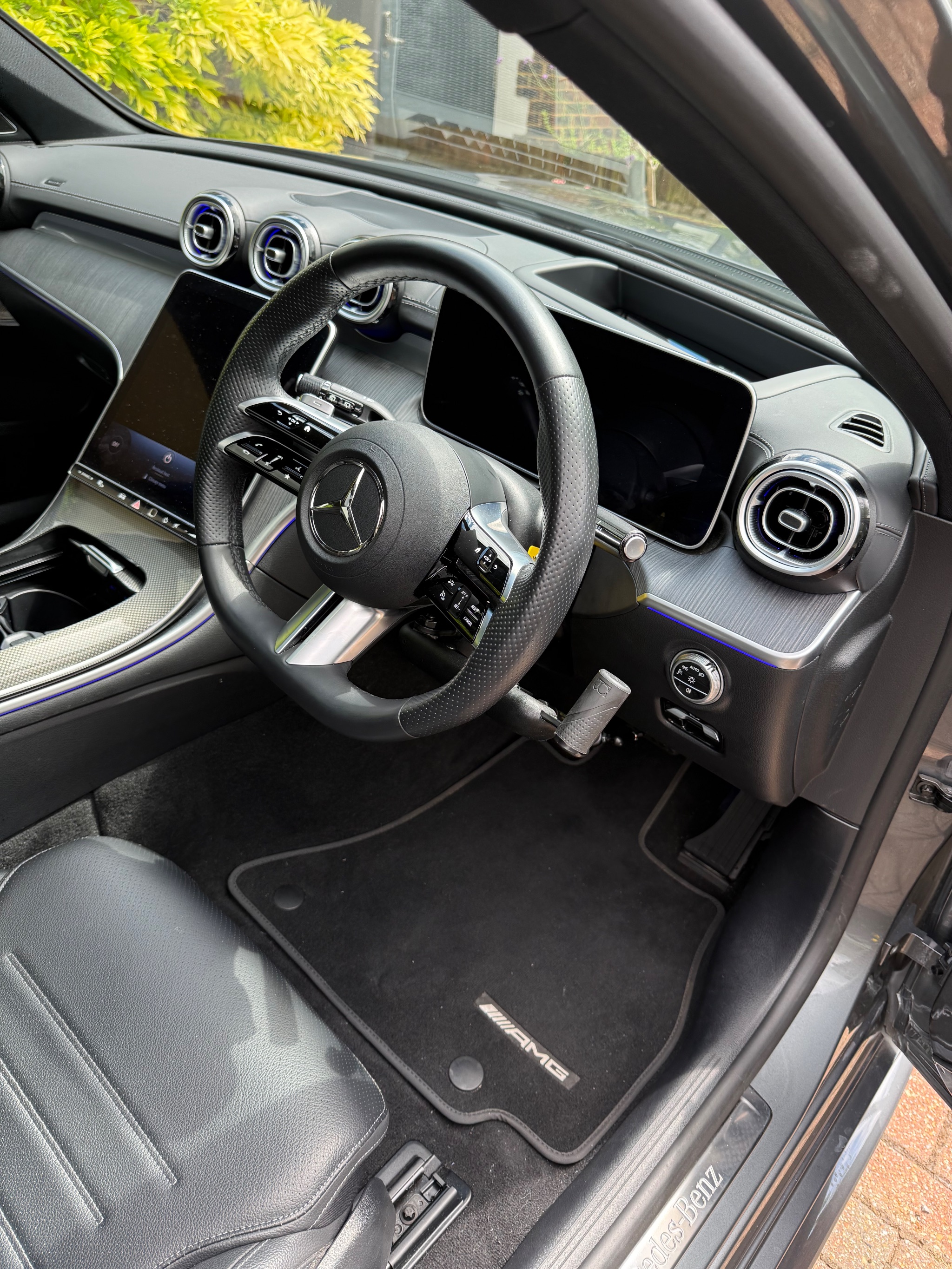 Push-pull hand controls installed beside the steering wheel of a Mercedes-Benz C-Class