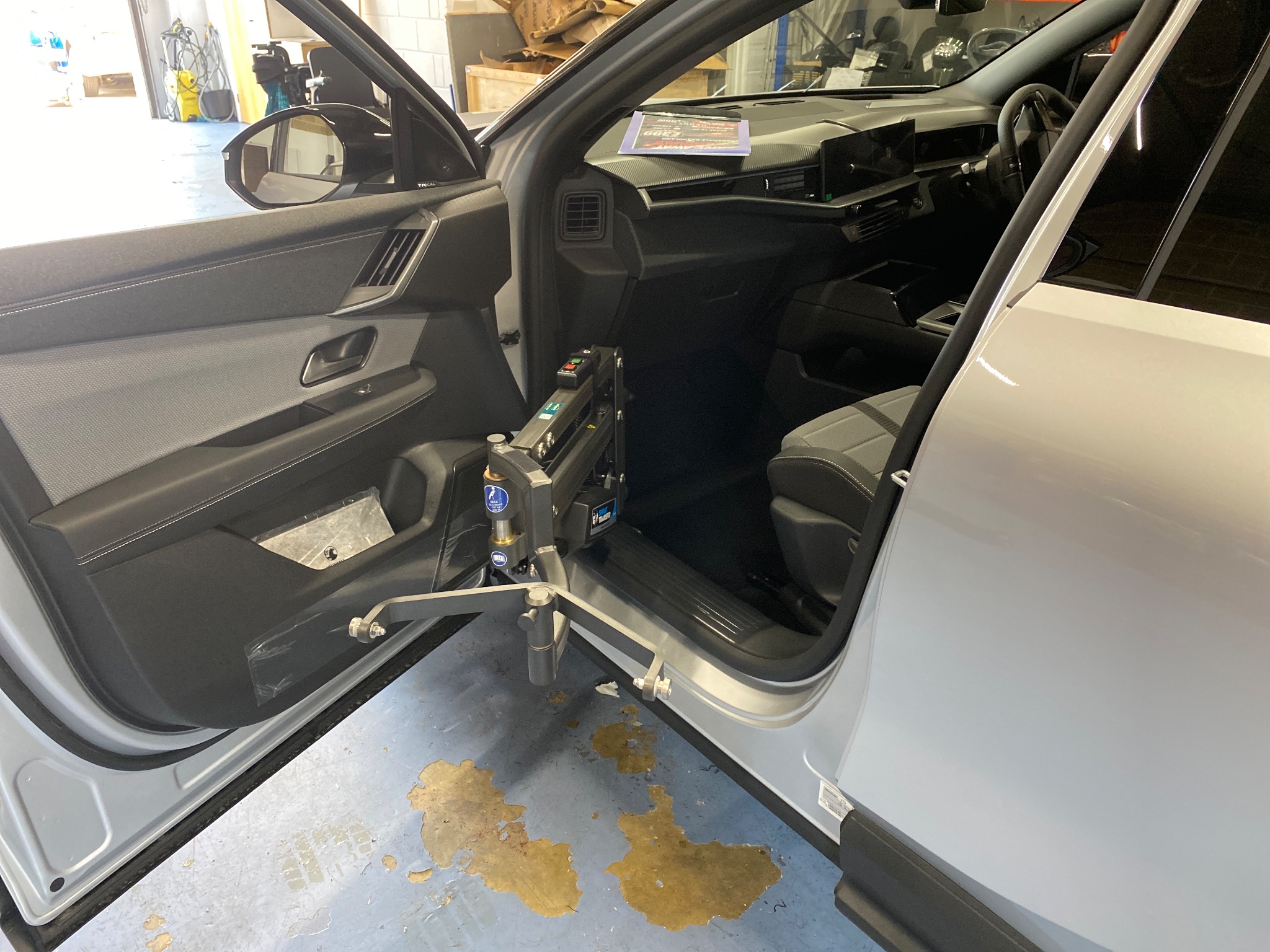 Close-up of the Autochair person hoist arm and mounting kit inside the vehicle