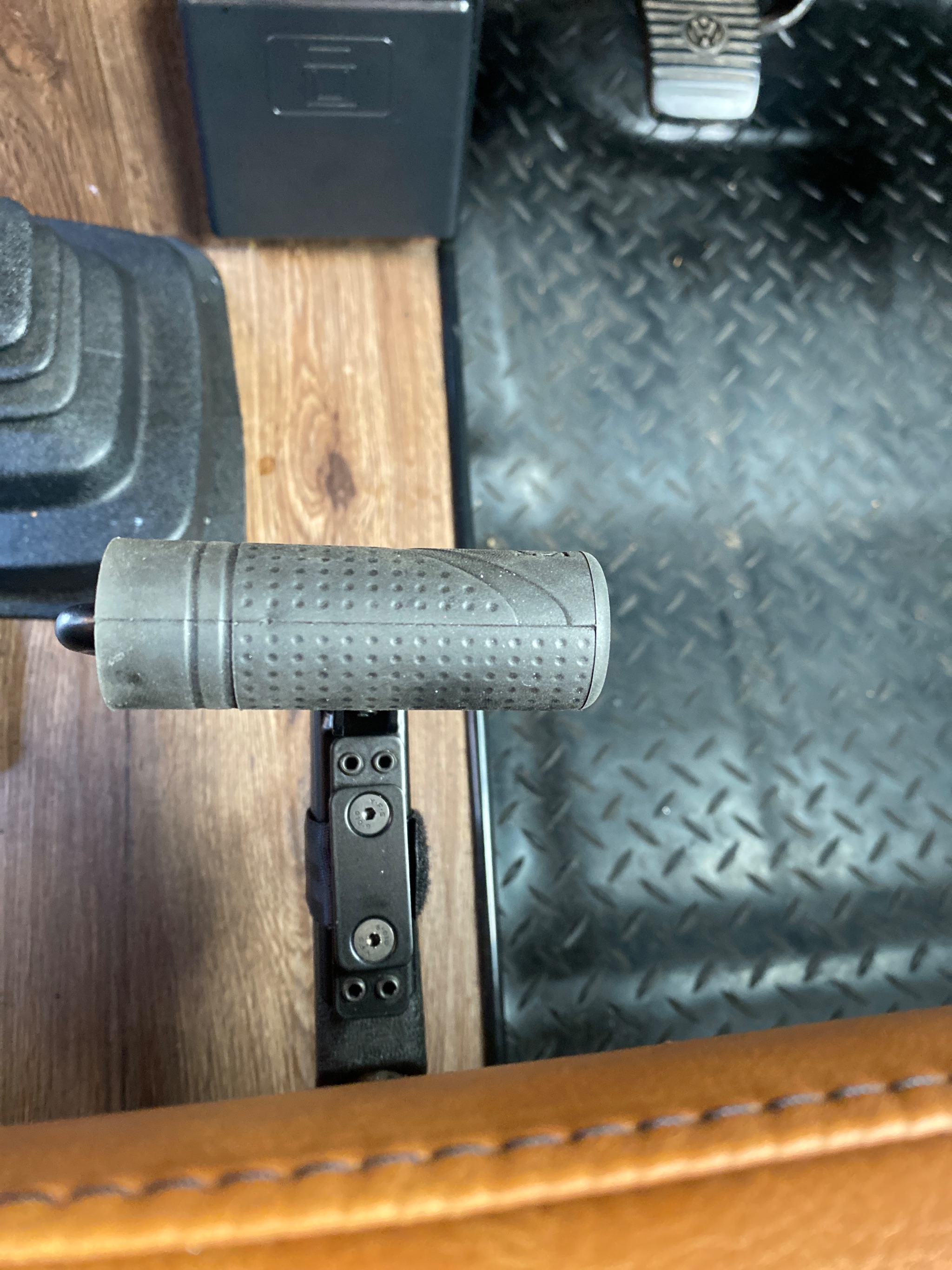 Close up view of the easy release handbrake adaptation mechanism inside the vehicle cab