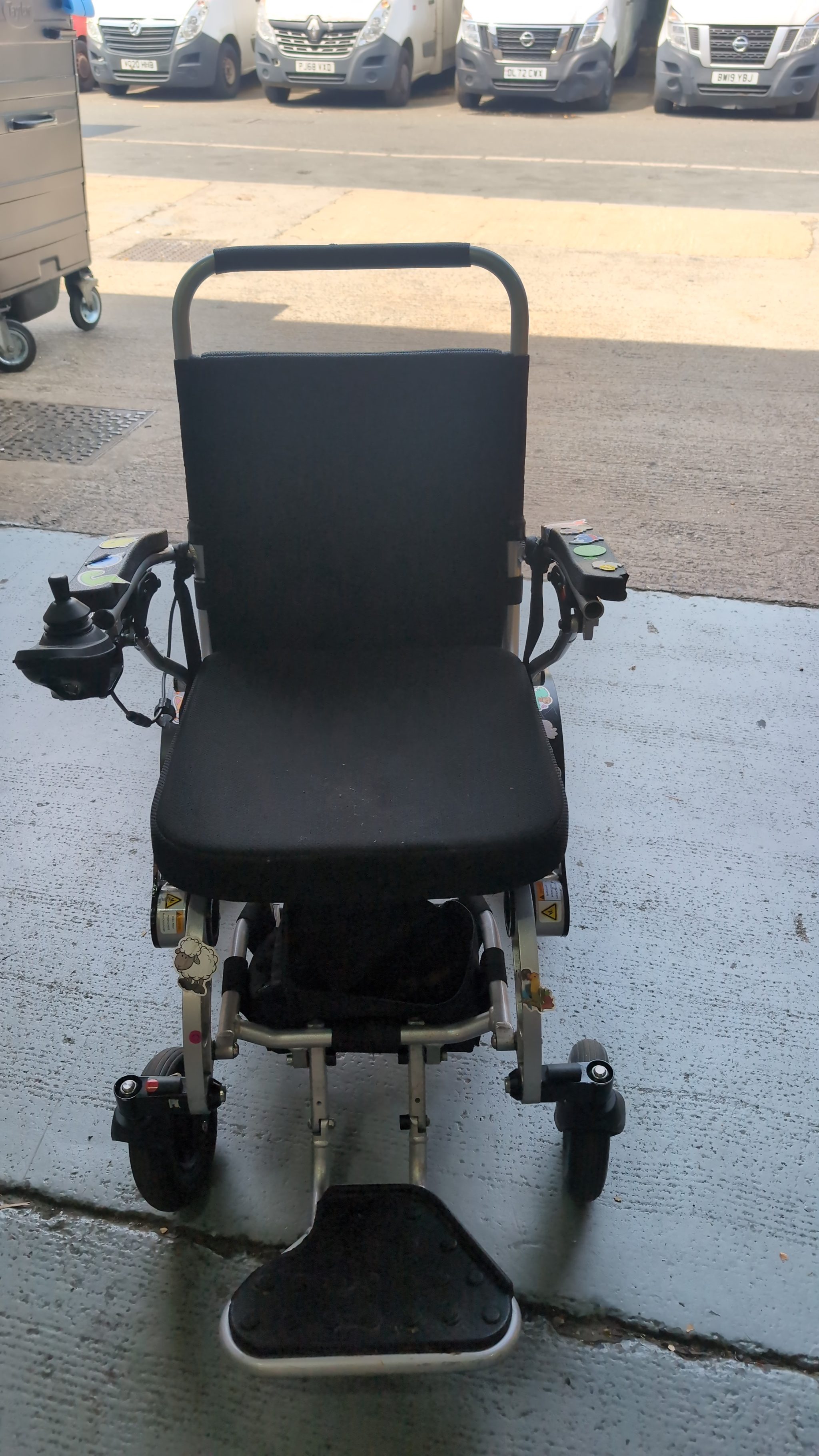 Technician fitting new castor fork to FreedomChair wheelchair