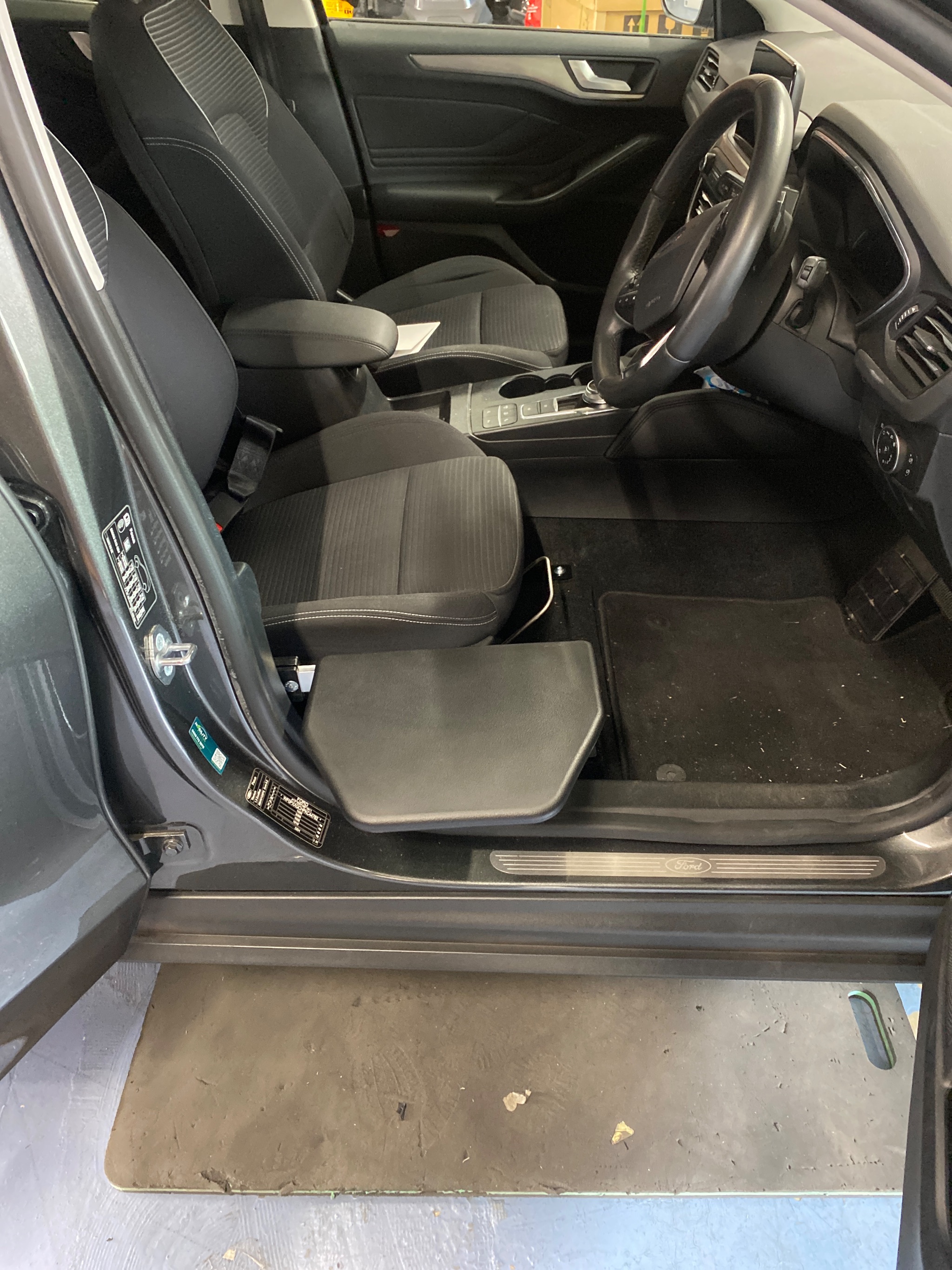Transfer plate folded down beside the driver seat ready for travel