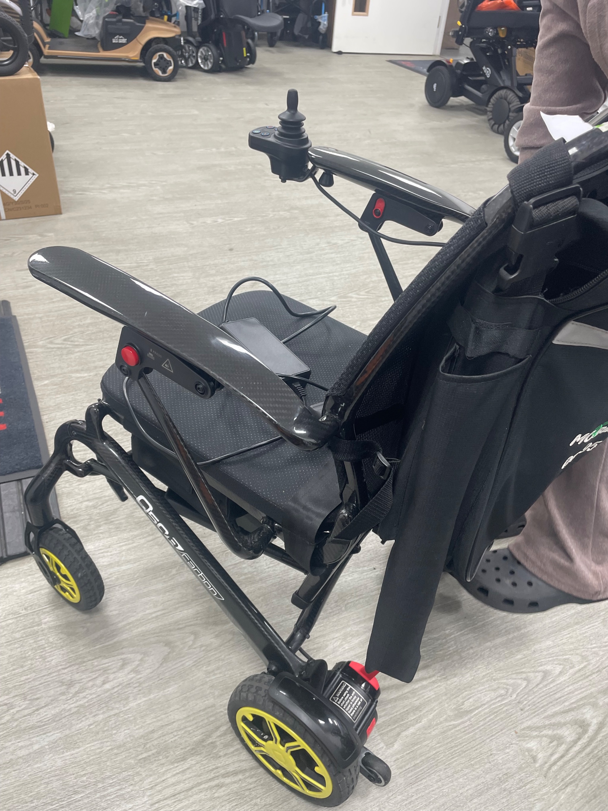 Technician testing the electrical contacts and battery on a powerchair