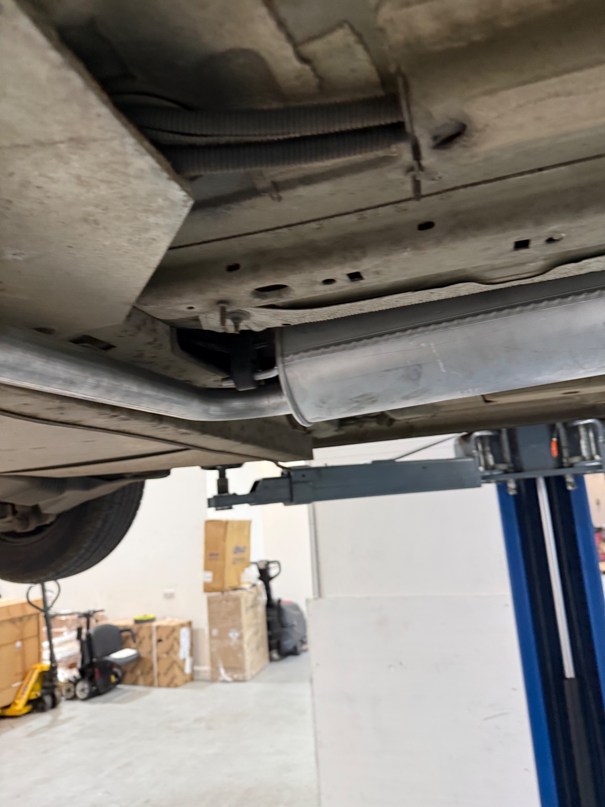 Technician inspecting the newly installed exhaust alignment