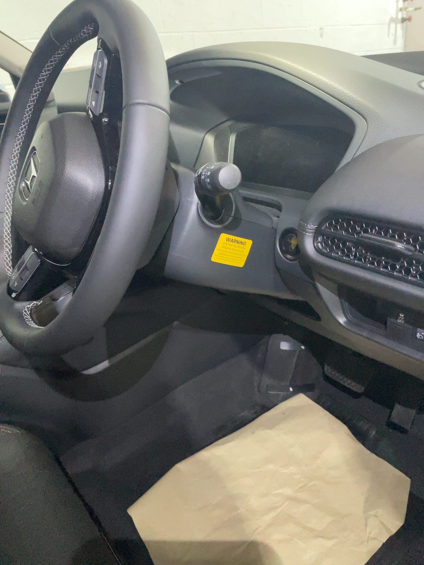 Twin flip folding left foot accelerator mechanism in driver footwell